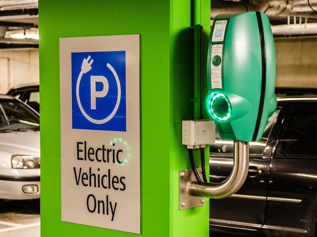 An electric vehicle charging station in a parking lot