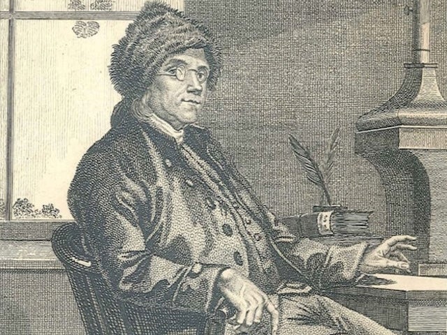 A drawing of Benjamin Franklin at his desk, next to a stove
