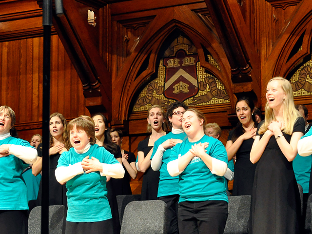 Choral singers from the Harvard-Radcliffe Collegium Musicum perform onstage at Sanders Theatre.