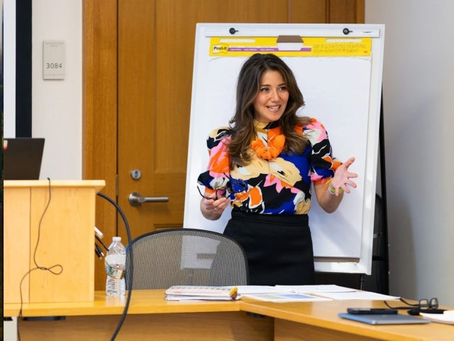  Betsy A. Miller ’99, a lecturer standing speaking to her class. 