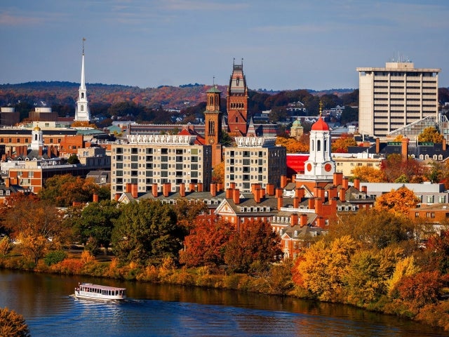 Aerial view of Cambridge, Harvard buildings and Charles River with fall foliage