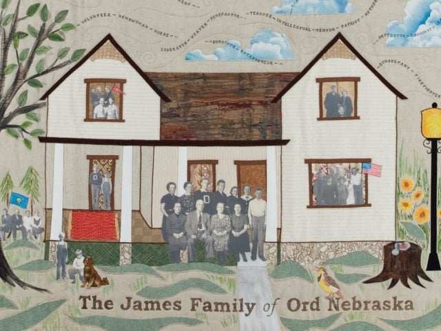 A quilt depicting members of the James family engaging in various activities in and around their house. Words in the sky above describe qualities of the James children, including "philanthropist," "volunteer," and "teacher."