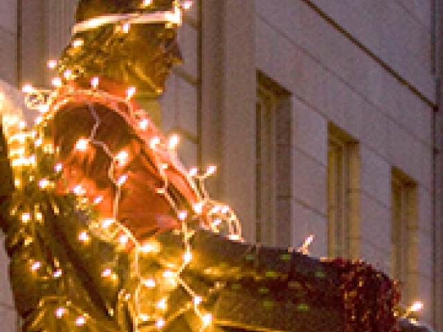 John Harvard statue in lights