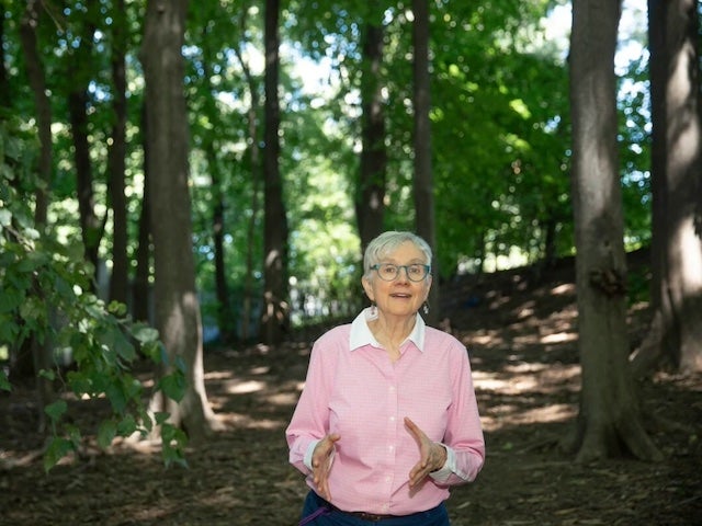 Loretta Mickley in a forest surrounded by trees