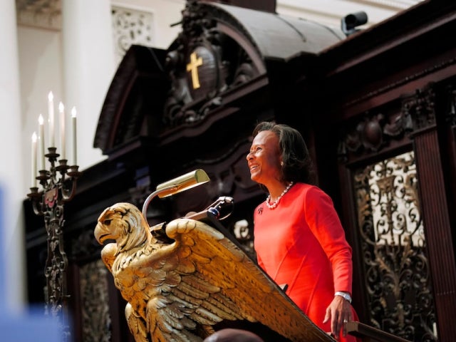 Paula Johnson speaks at an ornate eagle lectern inside Memorial Church