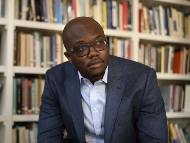 Chika Okafor in front of book shelves