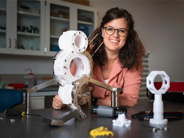 Assistant Professor of Applied Physics Giulia Semeghini smiles next to materials in the science lab