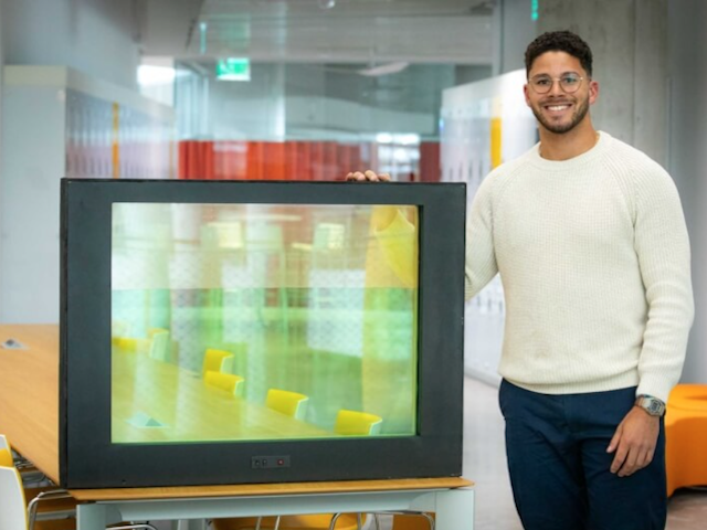 Brice Austin standing next to his liquid window prototype