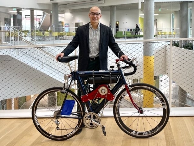Sebastian Lindner-Liaw standing behind the bike he designed
