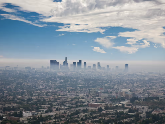 Panorama of city skyline marked by clouds and pollution