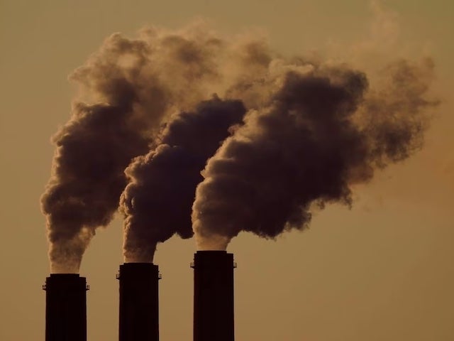 Emissions rise from the three smokestacks