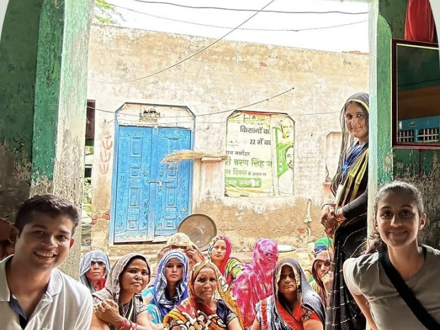 Rea Savla and fellow Solara co-founder Vishesh Mehta with a group of women in India