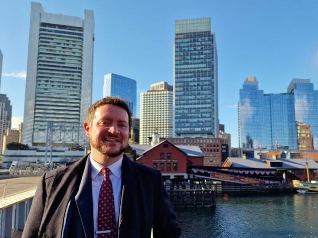 Ultan McCaffrey in downtown Boston with water and buildings in the background
