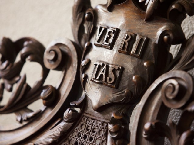 Close-up of a “Veritas” shield 