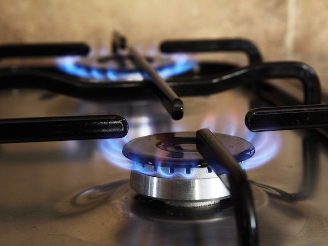 Two lit burners on a gas stove