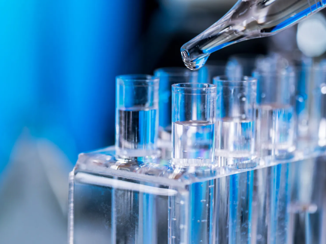 Detail of liquid being added to test tubes in a lab