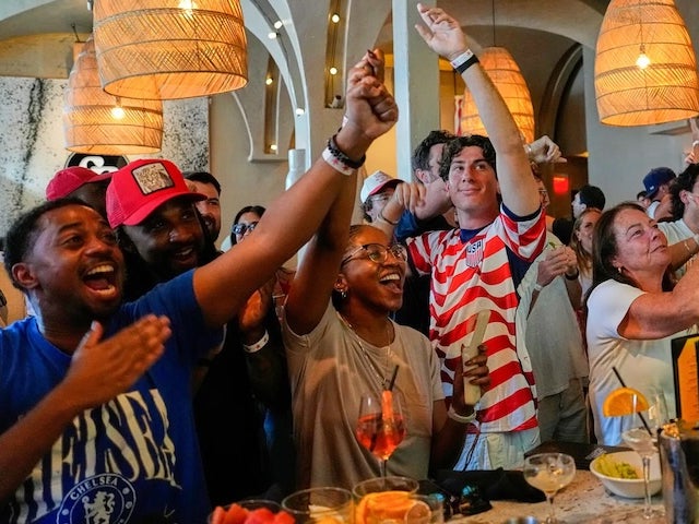 Fans cheering in a bar