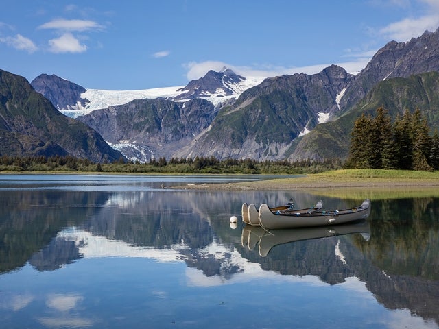 conoes on lake in front of mountain