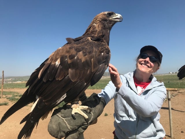 Cynthia M. Horne in Mongolia holding a Golden Eagle
