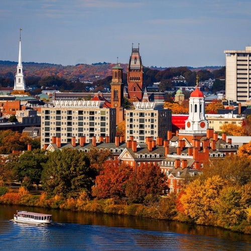 Aerial view of Cambridge, Harvard buildings and Charles River with fall foliage