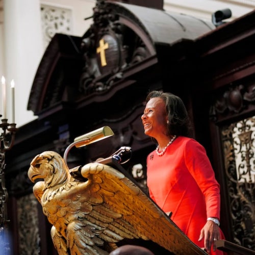 Paula Johnson speaks at an ornate eagle lectern inside Memorial Church