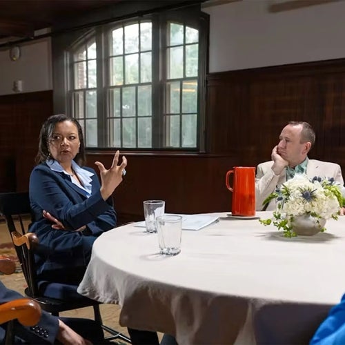 miko Brown-Nagin (center) and other scholars talk around a table