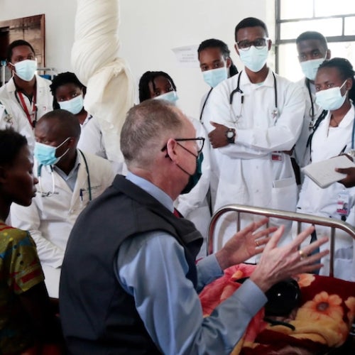 Paul Farmer teaches students from the University of Global Health Equity at a patient's bedside at Butaro District Hospital in Rwanda.