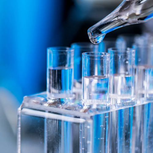 Detail of liquid being added to test tubes in a lab