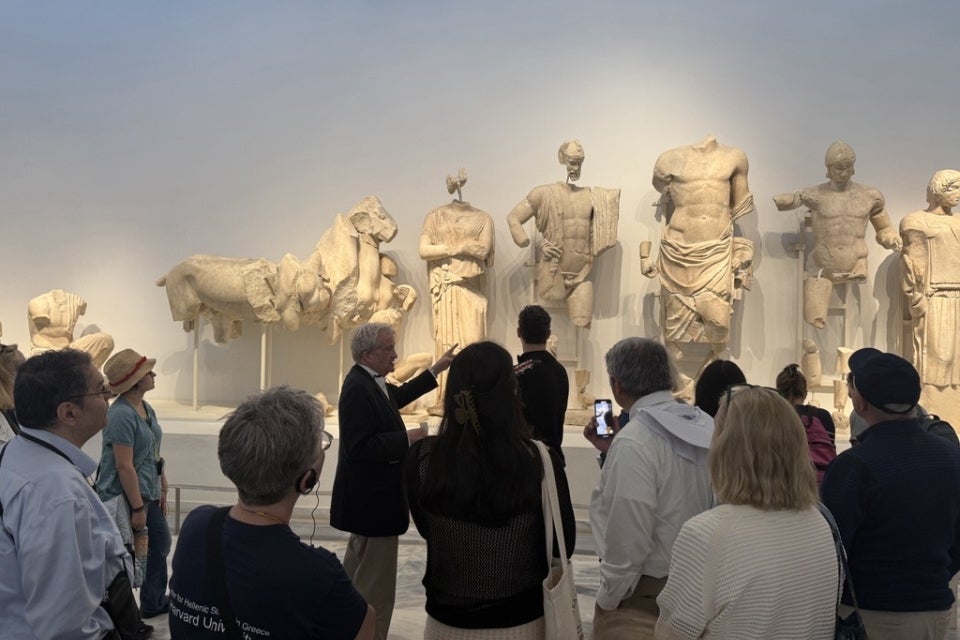 Professor Greg Nagy speaking to travelers at a museum