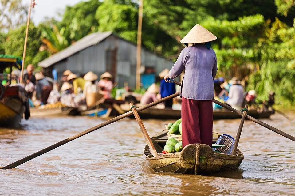 Woman rowing Mekong Delta