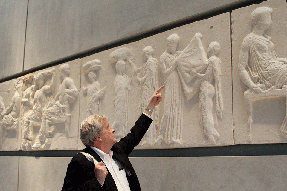Professor Greg Nagy pointing to art