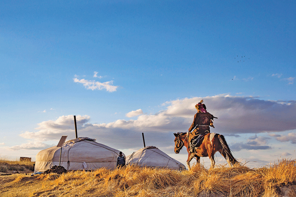 riding horse near tents